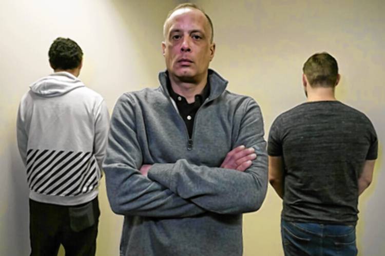 David Meehan, center, the lead plaintiff in a class-action lawsuit accusing the State of New Hampshire of covering up decades of sexual, physical and emotional abuse at its youth detention center, poses with two other victims who did not want to be identified, at his lawyer's office on Feb. 18, 2021, in Portsmouth, N.H. David Meehan, center, the lead plaintiff in a class-action lawsuit accusing the State of New Hampshire of covering up decades of sexual, physical and emotional abuse at its youth detention center, poses with two other victims who did not want to be identified, at his lawyer's office on Feb. 18, 2021, in Portsmouth, N.H.