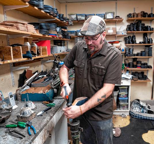 D.J. Annicchiarico, owner and part of fourth-generation cobblers at United Shoe Repair, has a small shop in downtown Concord.