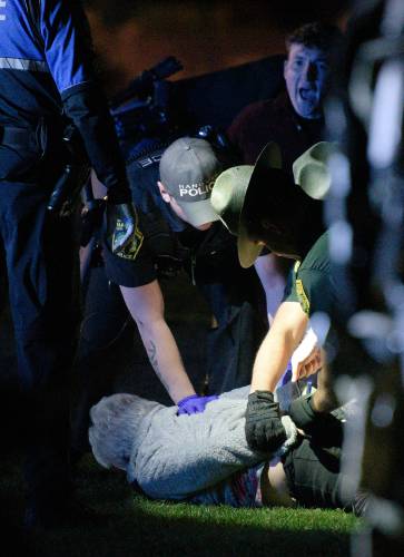 Dartmouth College Professor of History Annelise Orleck is held to the ground while being arrested during a protest of the Israel-Hamas War on the Green in Hanover, N.H., on Wednesday, May 1, 2024. (Valley News - James M. Patterson) Copyright Valley News. May not be reprinted or used online without permission. Send requests to permission@vnews.com.