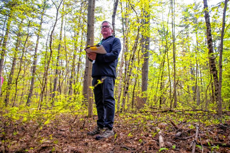 Director of Facilities & Planning  for the Concord School District Matt Cashman inspects one of the boring holes that were dug on the new middle school site near the Broken Ground School on Tuesday, May 14, 2024.