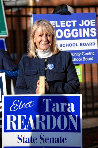 Tara Reardon, Democratic candidate for State Senate District 15, holds a sign outside the Green Street Community Center in Concord.