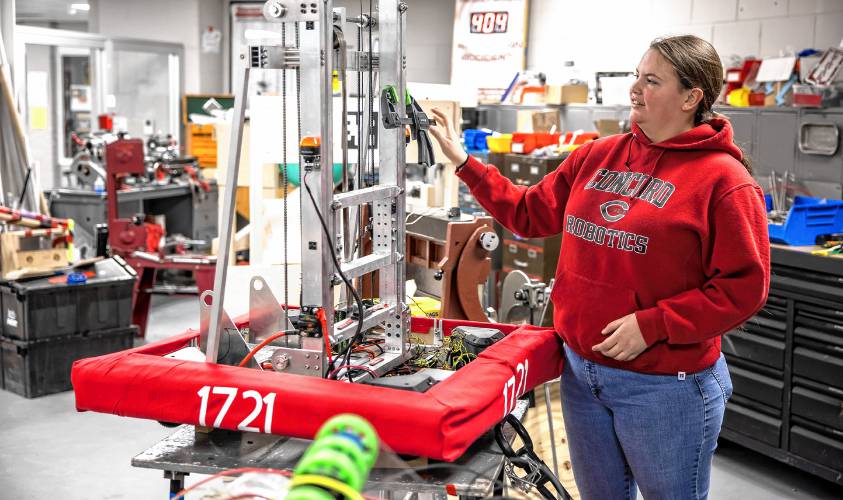 Concord High School senior Laura Lorenze looks over the team robot on Wednesday, Feb. 26.. The team has a competition match this Saturday.