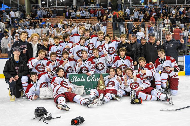 The Concord High School boys’ hockey team celebrates after defeating Bishop Guertin, 2-1, in four overtimes to claim the Division I championship on Saturday.