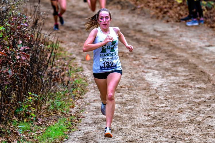 Hopkinton’s Maddy Lane exits the woods halfway through the 5K at the NHIAA Meet of Champions on Saturday. Lane finished seventh in the girls’ race to qualify for New Englands.