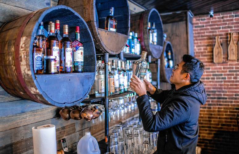 Trumin Nguyen fills up the bar after getting a liquor shipment at the new Buba Kitchen, that will be replacing the old Whiskey and Wine location at 148 North Main Street in downtown Concord. Nguyen plans on opening the restaurant early next month.