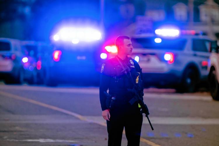 A police officer blocks the entrance to New Hampshire on Clinton Street in Concord following a report of a shooting at New Hampshire Hospital. Police reported multiple victims. 