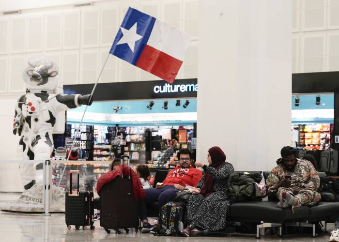 Travelers wait in Terminal A at George Bush Intercontinental Airport, Tuesday, Nov. 21, 2023, in Houston. (Jason Fochtman/Houston Chronicle via AP)