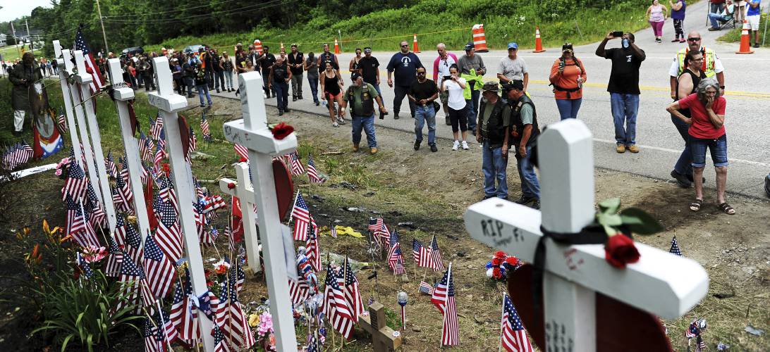 In this July 6, 2019,  photo, motorcyclists visit a memorial for seven bikers killed in a collision with a pickup truck last month while participating in the Ride for the Fallen 7 in Randolph. 