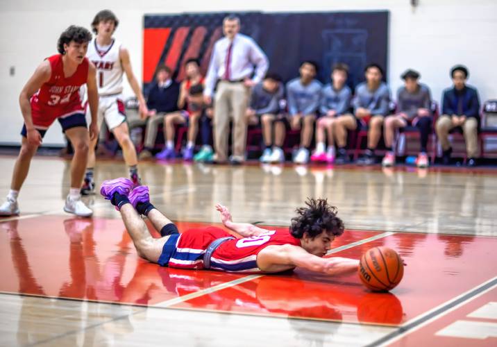 John Stark guard Logan Montgomery lunges for a loose ball during the first half on Tuesday, February 6, 2024.