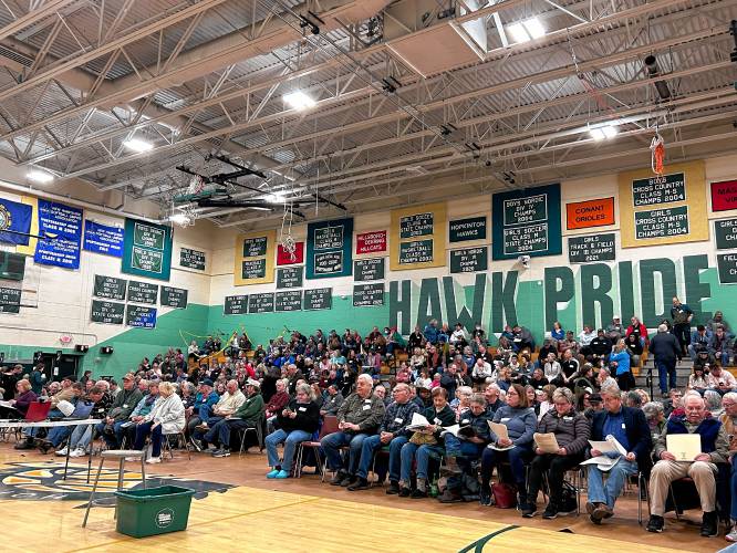 Residents gathered at the Hopkinton High School’s gym for town meeting on Thursday evening