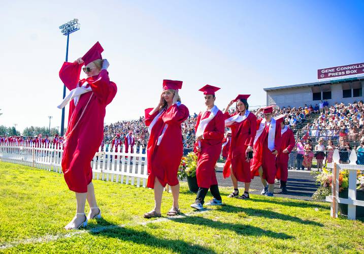 Concord High School graduates have to hold on to their caps as a strong gust of wind blew through Memorial Field as they entered to receive their diplomas on Saturday, June 15, 2024.