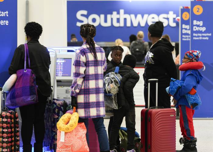 Travelers check in at Southwest Airlines at George Bush Intercontinental Airport, Tuesday, Nov. 21, 2023, in Houston. (Jason Fochtman/Houston Chronicle via AP)