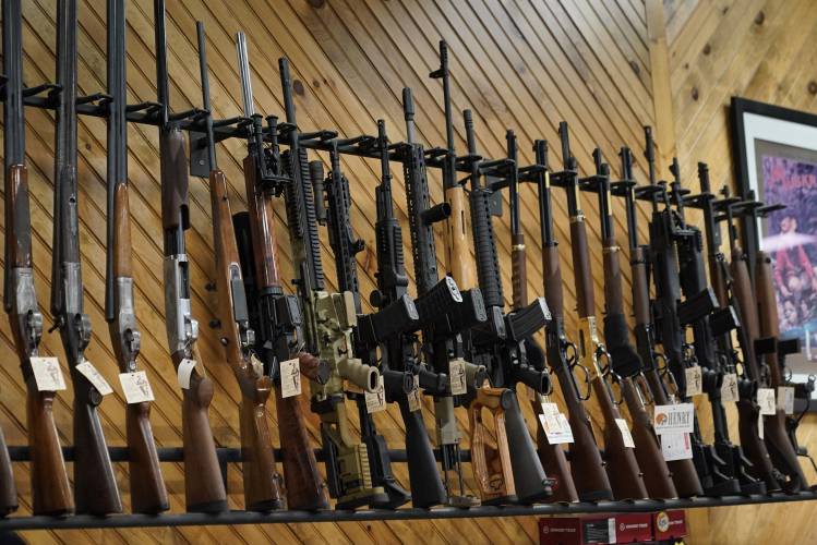 Various guns are displayed at a store on July 18, 2022, in Auburn, Maine. 
