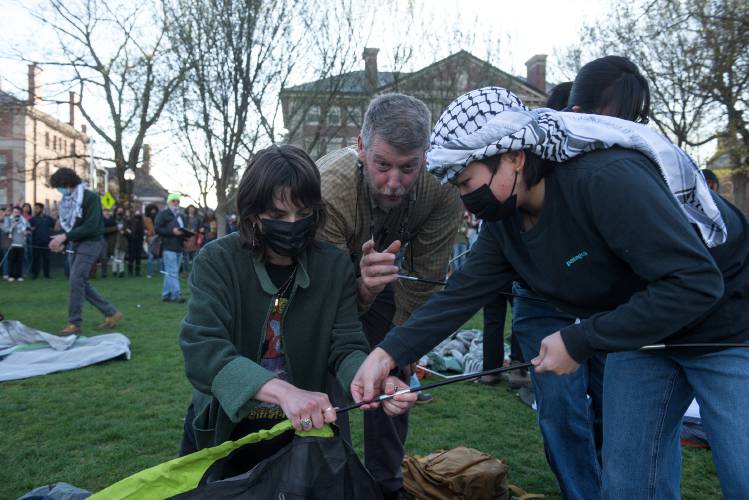 Greg Timmins, of Dartmouth College Safety and Security, warns students putting up tents on the Green as part of a protest of the Israel-Hamas War that they are violating Dartmouth College policy and will be arrested, in Hanover, N.H., on Wednesday, May 1, 2024. (Valley News - James M. Patterson) Copyright Valley News. May not be reprinted or used online without permission. Send requests to permission@vnews.com.