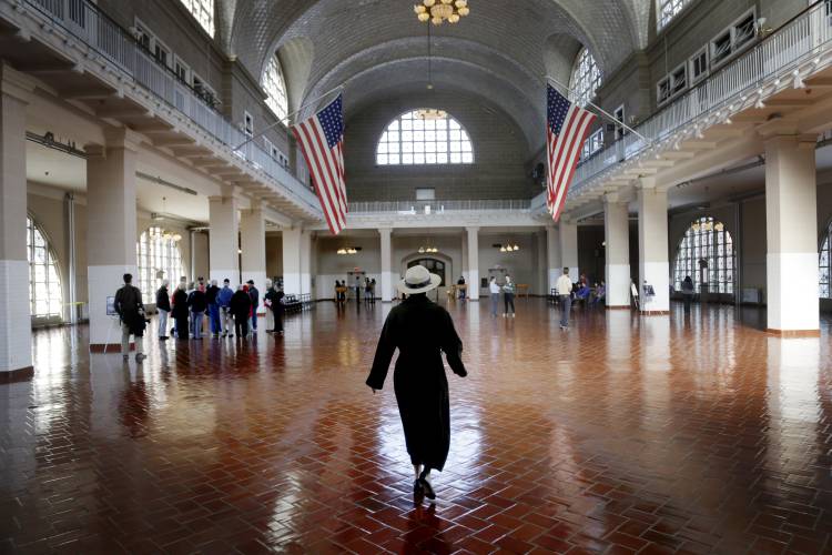 A park ranger walks through the registry room on Ellis Island in New York.