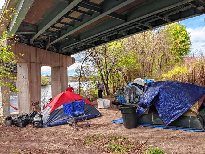 Fire Chief Dan Goonan and Fire/EMS Officer Chris Hickey do rounds at an encampment for the homeless under the Amoskeag Bridge on May 15.