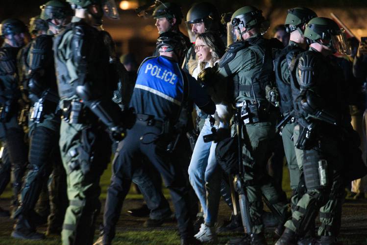 A student is arrested during a protest of the Israel-Hamas War on the Dartmouth College Green in Hanover, N.H., on Wednesday, May 1. Protesters demanded that the university divest from companies in Israel. 