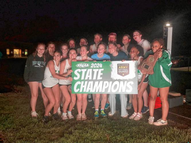 The Hopkinton girl’ track and field team poses with hardware after winning the Division III team title at Winnisquam Regional High School on Thursday.