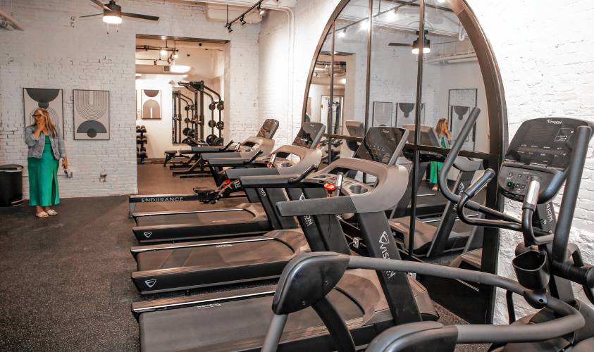 Elizabeth Stewart, property manager for the Steven Mills complex, shows the workout area on Thursday, August 1, 2024. The former mill building is fully occupied and the final construction operations ended on Thursday.