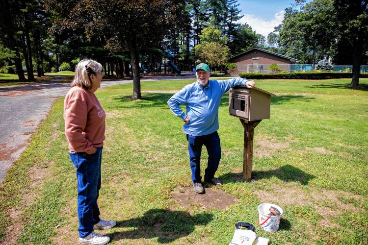  Mary McEvoy-Barrett and her husband, Ray Barrett, of Concord at the Little Free Library at Rollins Park.