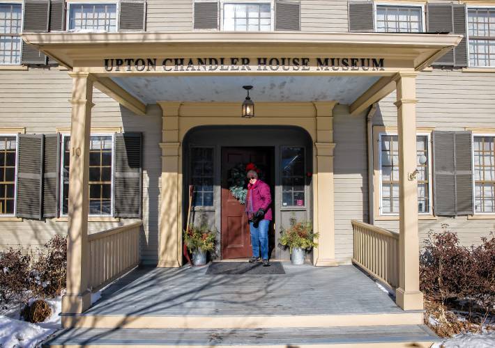 Hometown Hero Rebecca Courser comes out of the front door of the Upton Chandler House Museum in downtown Warner on Wednesday.