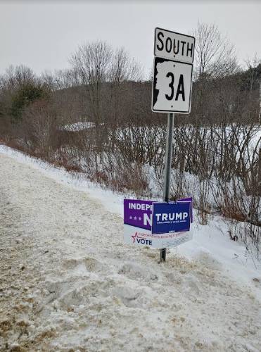 A Donald Trump campaign sign was clamped on top of a Nikki Haley sign on Route 3A in Hill, N.H.