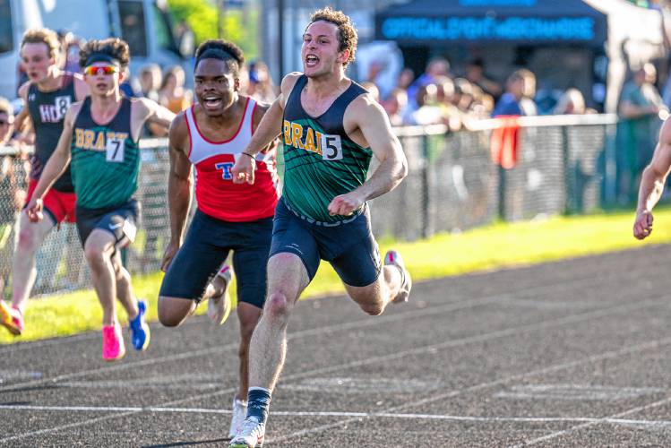 Bishop Brady’s Josh Gentchos crosses the finish line to win the 100-meter finals at the NHIAA Division III track and field championship at Winnisquam Regional High School on Thursday. Gentchos clocked a time of 10.65 seconds, breaking the state record. Gentchos also anchored the D-III record-breaking 4x100-meter relay.