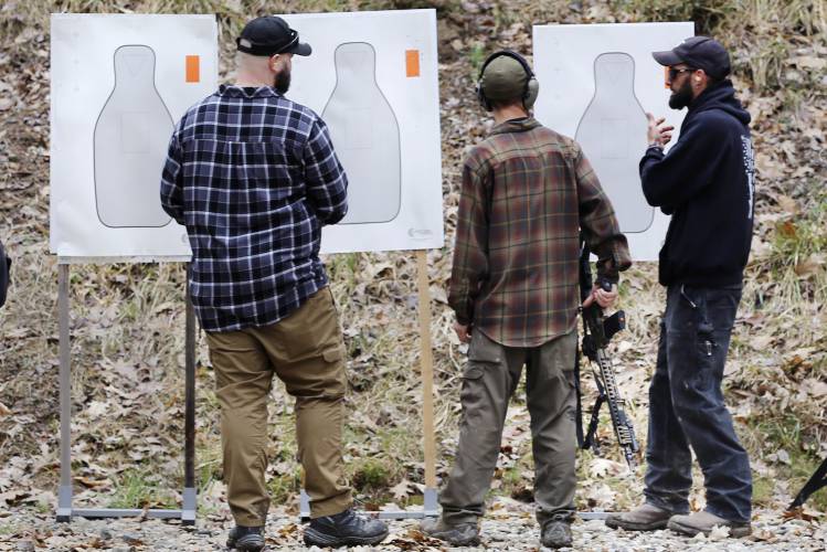 People look at targets during a pause in a shooting session at Slate Ridge, an unpermitted gun range and firearms training center, Saturday April 17, 2021, in West Pawlet, Vt. A judge has again issued an arrest warrant, Monday, Dec. 4, 2023, for Daniel Banyai, the owner of the former firearms training center in Vermont, ruling that he is in contempt of court for failing to bring his property into compliance after an inspection last week. Monday's ruling orders him to turn himself...
