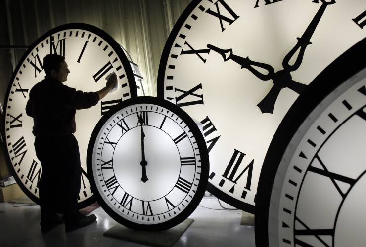 FILE - Electric Time Co. employee Walter Rodriguez cleans the face of an 84-inch Wegman clock at the plant in Medfield, Mass. Thursday, Oct. 30, 2008. Once again, most Americans will set their clocks forward by one hour this weekend, losing perhaps a bit of sleep but gaining more glorious sunlight in the evenings as the days warm into summer. There's been plenty of debate over the practice but about 70 countries — about 40 percent of those across the globe — currently use what...