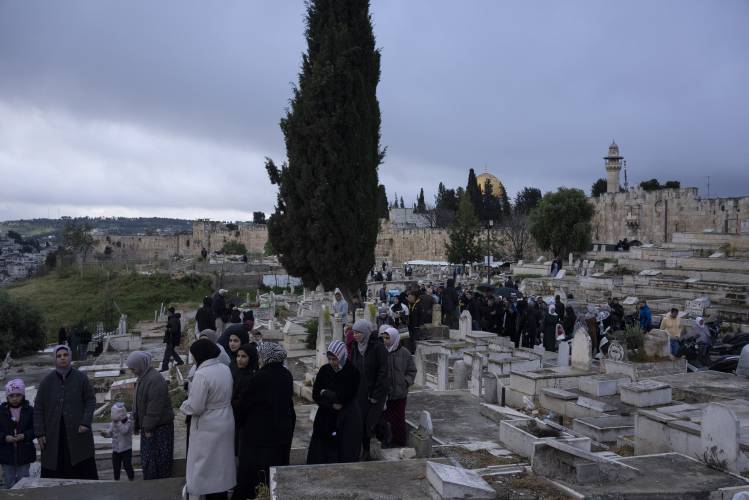 Palestinians visit the graves of their relatives after Eid al-Fitr prayers, during the celebrations at the end of the Muslim holy fasting month of Ramadan, at a cemetery just outside Jerusalem’s Old City walls, on April 10. Palestinians visit the graves of their relatives after Eid al-Fitr prayers, during the celebrations at the end of the Muslim holy fasting month of Ramadan, at a cemetery just outside Jerusalem’s Old City walls, on April 10.