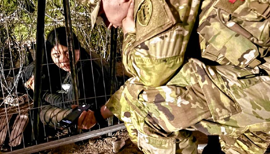 New Hampshire National Guard Lt. Ryan Camp uses Google Translate to communicate with a woman who spent two nights at the border fence in Eagle Pass, Texas seeking asylum.