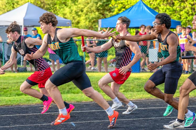 Bishop Brady’s Joshua-Stephen Bissah (right) hands off to teammate Seamus McIntyre in the 4x100-meter relay at the NHIAA Division III track and field championship on Thursday at Winnisquam Regional High School. Bishop Brady won the relay in 43.25 seconds, setting a new division record.