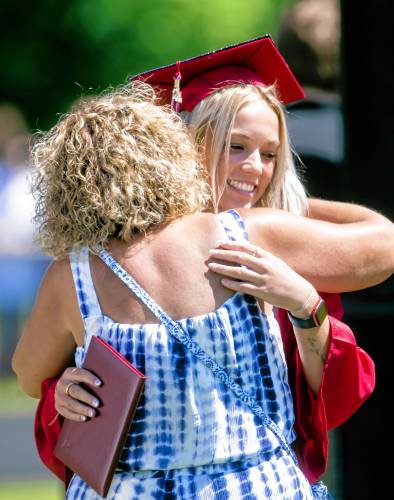 Concord High School graduate Kendall Barton gets a hug from Administrative Assistant to the Principal Lisa Lamb after Barton received her diploma at Memorial Field on Saturday, June 15, 2024.