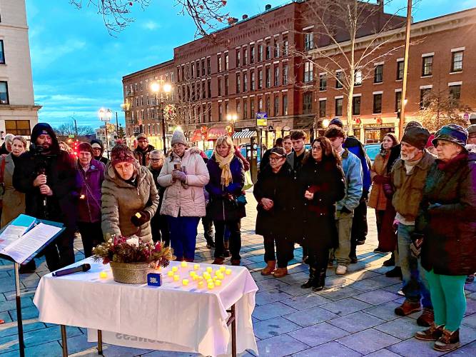 Karen Jantzen, executive director of the Concord Coalition to End Homelessness, placed two candles on the table at the vigil at City Plaza – one for one of the 54 homeless individuals who died and one for Hope Butterworth, the founder of the Friendly Kitchen, who died last year as well.