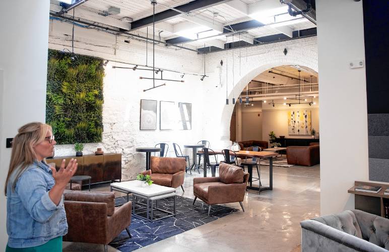 Elizabeth Stewart, property manager for the Stevens Mill complex, shows a common area in the apartment portion on Thursday. The former mill building is fully occupied and the final construction operations ended on Thursday.
