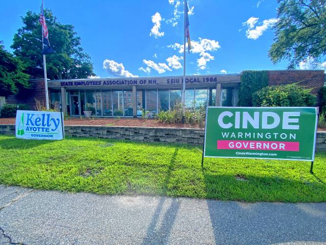 Signs for gubernatorial candidates Kelley Ayotte, a Republican, and Cinde Warmington were placed in the grass outside the State Employees Association headquarters on North Main Street in Concord. Signs for gubernatorial candidates Kelley Ayotte, a Republican, and Cinde Warmington were placed in the grass outside the State Employees Association headquarters on North Main Street in Concord.