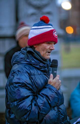 Larry Regan recites a poem to the crowd gathered at City Plaza in front of the State House in honor of his late wife and acknowledged his fight with homelessness on Thursday night, December 19, 2024 . “I’m actually one of the lucky ones,” he said. “I made it out.”