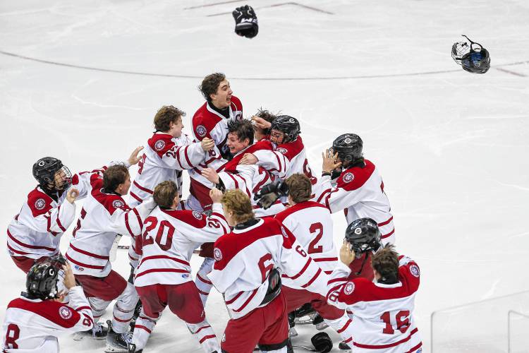 The Crimson Tide boys’ hockey team celebrates after winning the longest championship game in NHIAA hockey history with a 2-1 victory in quadruple overtime. 