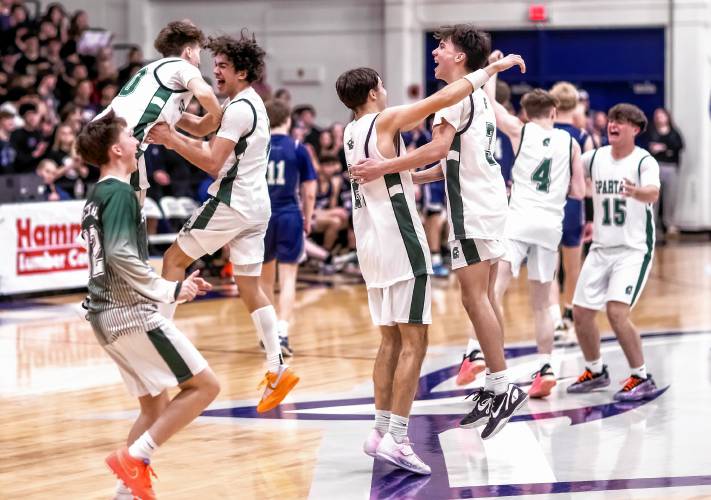 Pembroke players storm the court after they won the D-II boys’ basketball championship on Sunday.