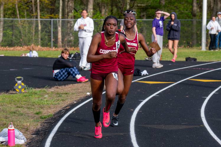 Concord’s Ballay Conteh (back) hands off to anchor Grace Saysaw (front) for the final leg of the 4x100-meter relay at the Merrimack Invitational on May 9. Conteh, Saysaw, Chelsea Toenah and Ella Goulas set the school record, and are all back this spring.