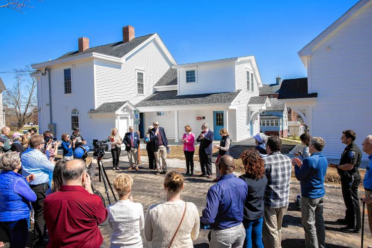 The crowd claps at the opening celebration of the new apartment complex to house the formerly homeless on Tuesday, April 23.