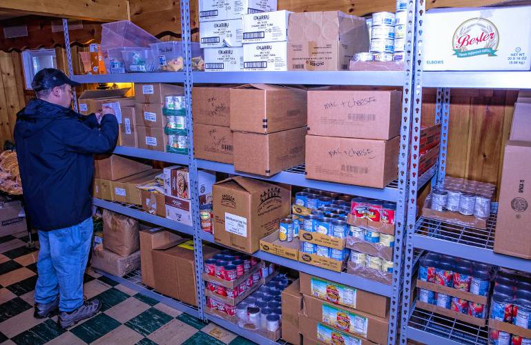 Coordinator Anthony Palmieri checks on the inventory in the food bank at the basement of the Early Head Start building in Pittsfield.