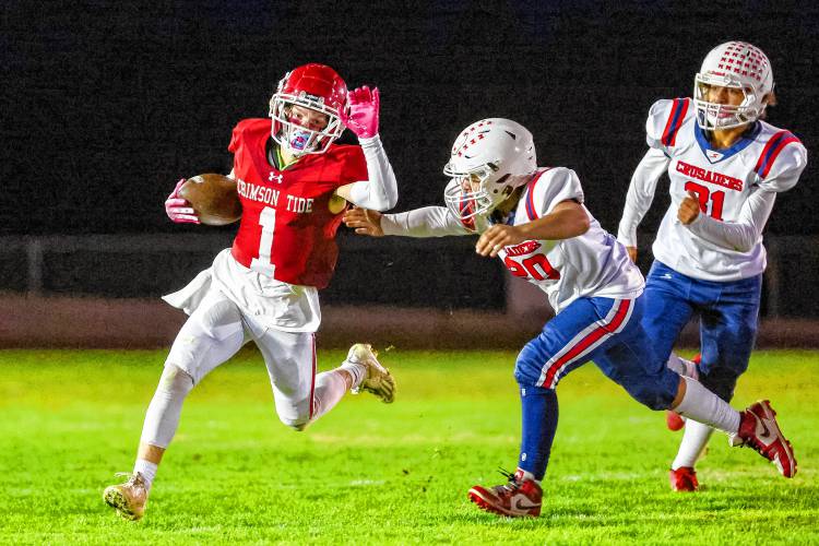 Concord’s Trevor Craigue (1) runs with the ball after making a catch during a football game against Manchester Memorial on Thursday. Craigue scored two touchdowns as Concord defeated Memorial, 21-12.