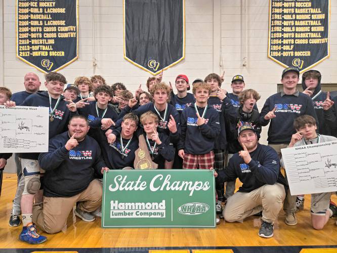 The Bow Falcons celebrate back-to-back Division III titles after winning the D-III wrestling championship on Saturday at ConVal Regional High School.