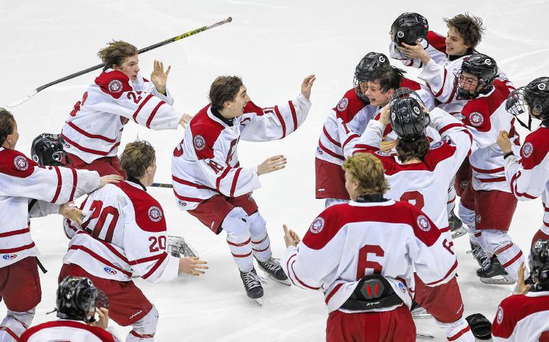Concord players celebrate after winning the longest championship game in NHIAA hockey history with a 2-1 victory in quadruple overtime.