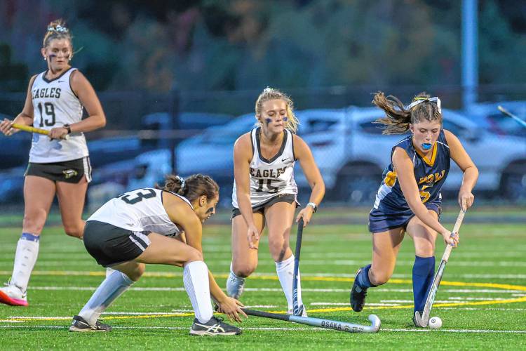 Shire Kelley (5) tries to keep the ball away from Kennett’s Grier Carrier (15) and Eliana Newton (23).