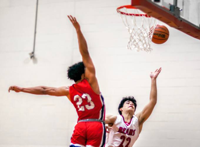 Coe-Brown guard Matthew Flanagan drives to the basket over the outstretched arm of John Stark forward Donnie White during the first half on Tuesday night.