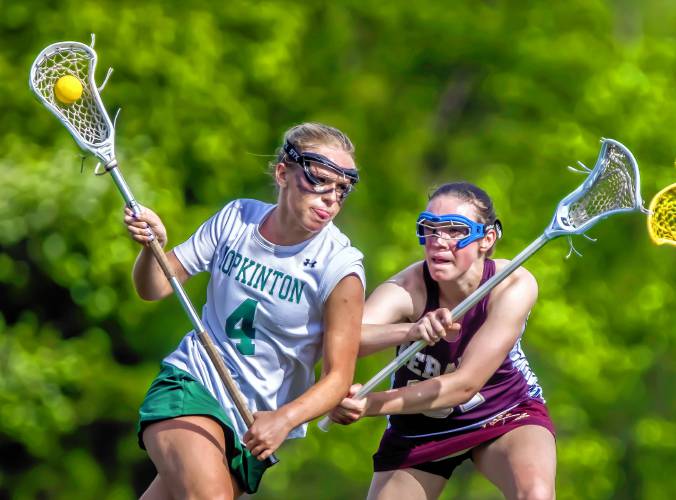 Hopkinton midfielder Sarah Chodosh is tracked by Lebanon midfielder Biff Mayer during the second quarter on Monday.