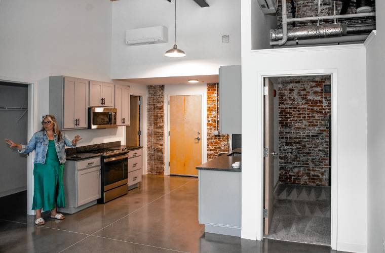 Elizabeth Stewart, property manager for the Stevens Mill complex, showa a two bedroom apartment on Thursday, August 1, 2024. The former mill building is fully occupied and the final construction operations ended on Thursday.