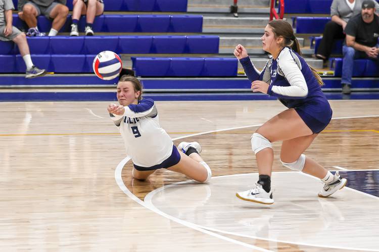 Merrimack Valley’s Mackenzie Shelby (9) dives to dig the ball during the Pride's first ever home varsity volleyball match on Friday.